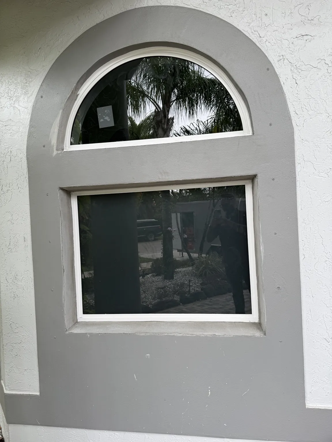Completed arched and rectangular impact window combination